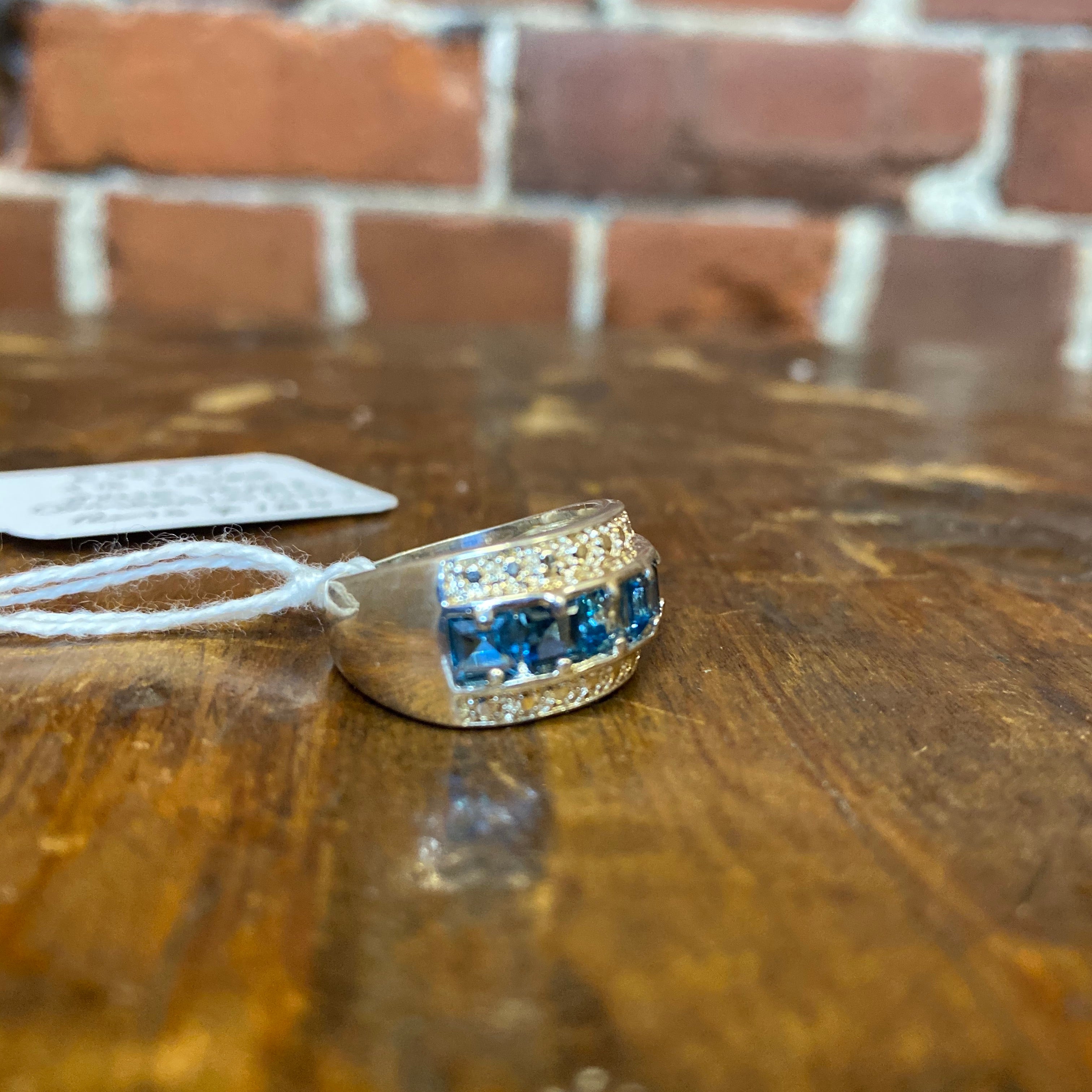 Sterling silver and emerald cut, blue topaz ring